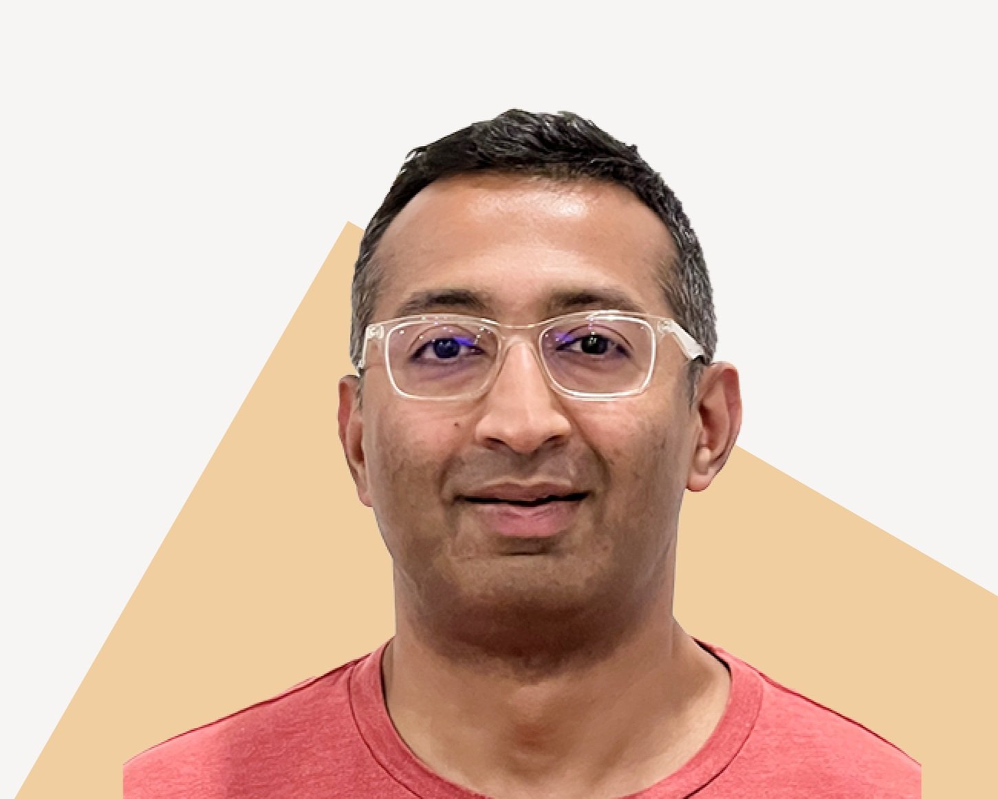 Dilip Krishnan, Senior Staff Research Scientist at Google, smiling in glasses and red shirt.