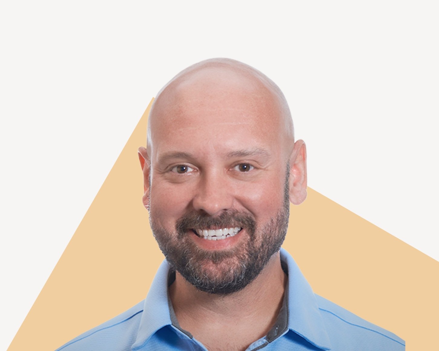 Clint Hedin, Entrepreneur, smiling in a blue collared shirt.