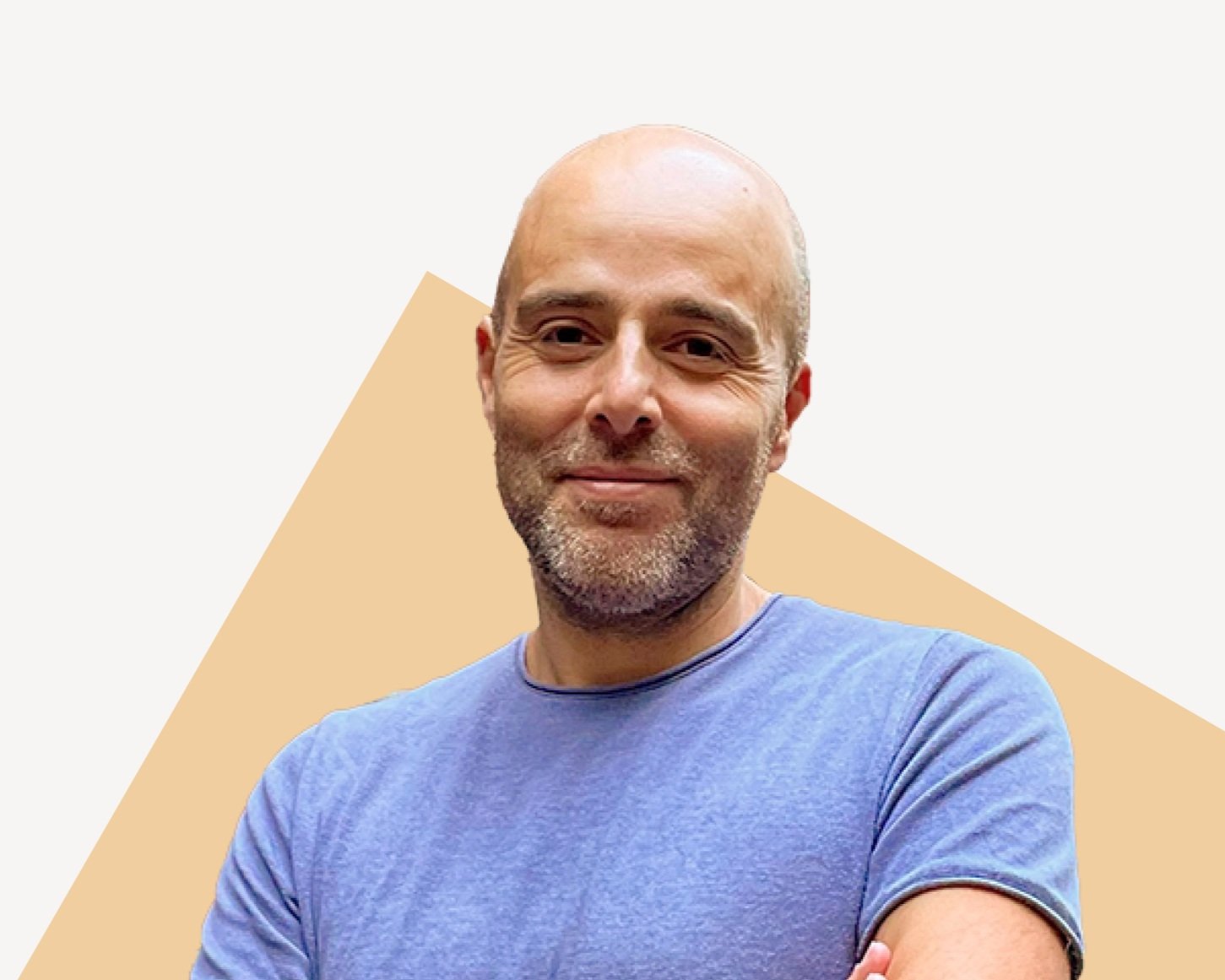 Emre Akkas, M&A Advisor and Startup CEO Coach, smiling in a blue shirt.